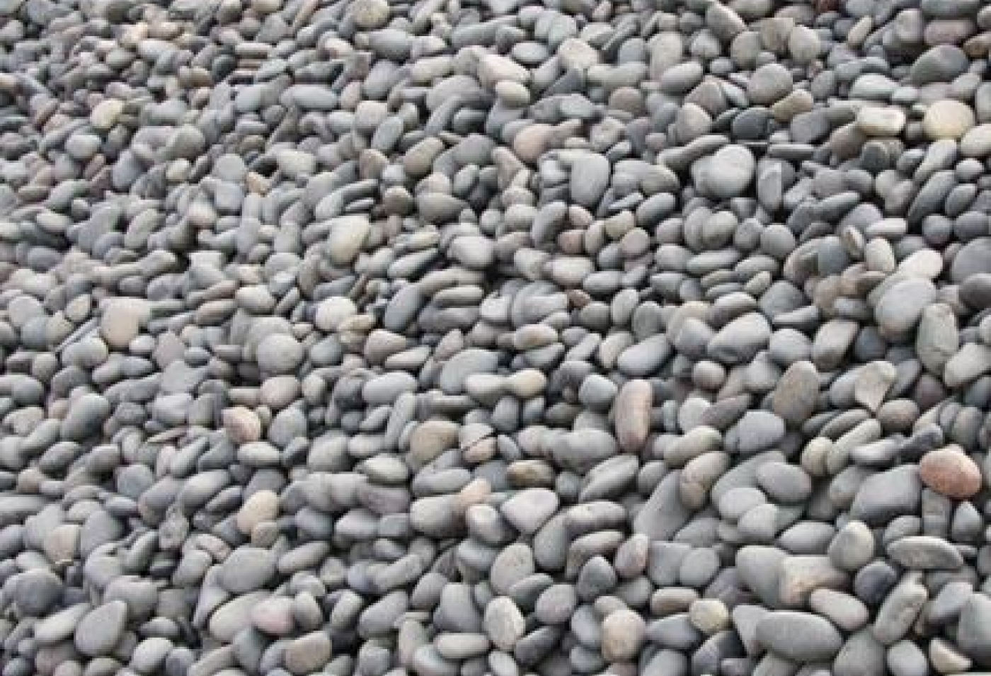 Walkway on the side with partial pebbles and river sand